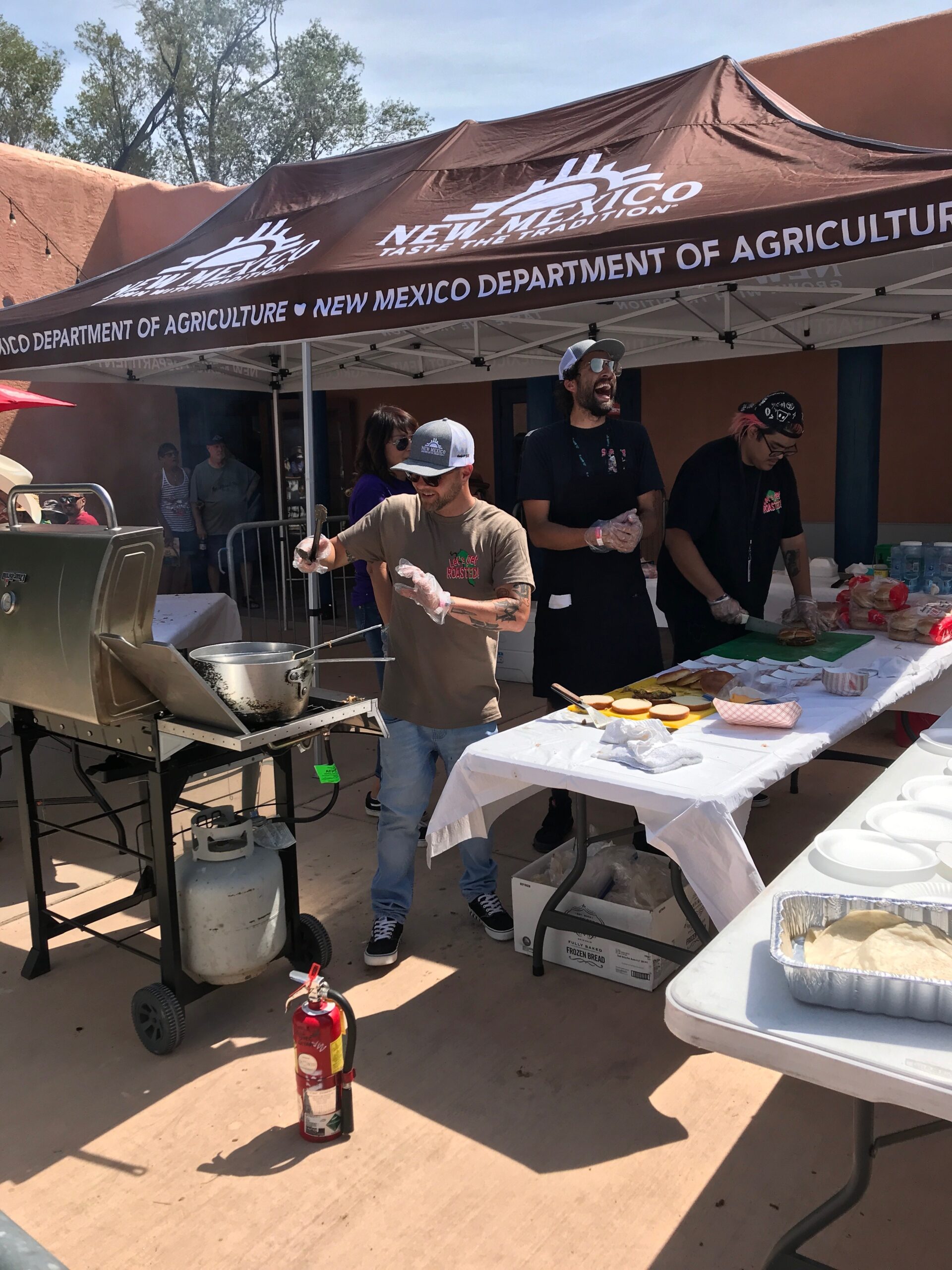 men grilling green chile cheeseburgers